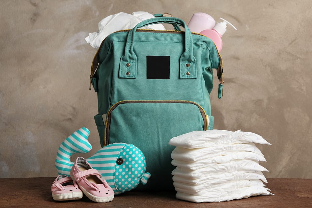 Changing Bag with nappies and baby products on a table