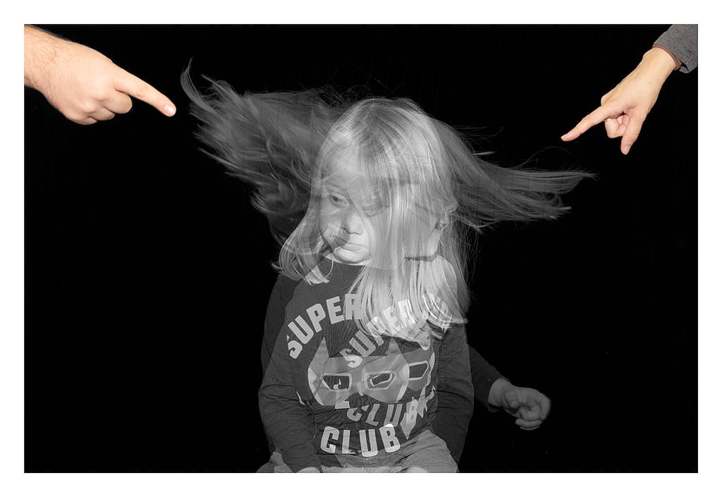 A superimposed image of a child, with parents pointing at him. Demonstrating their parenting style