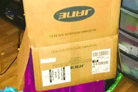 A close up of a pushchair box over the top of somebody