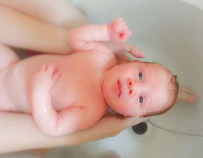 A close up of a baby in a bath