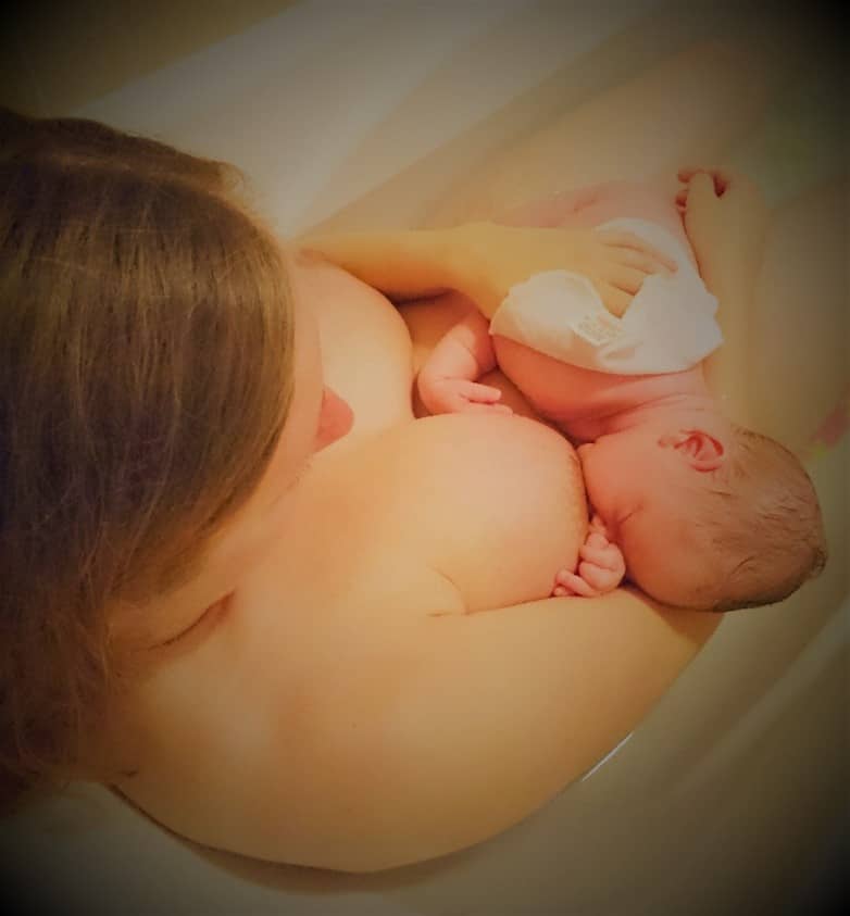 A shot of the shoulder of a mother breastfeeding her baby in the bath